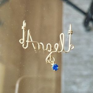 Gold Angel necklace pendant with sapphire stone.